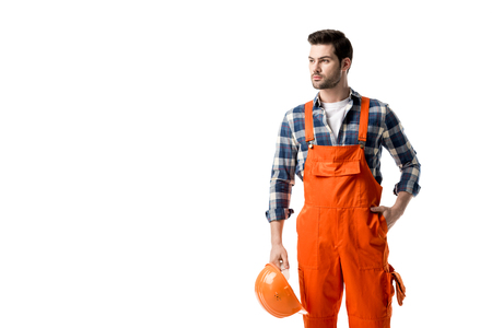 Repairman in orange overall holding hard hat isolated on whiteの写真素材