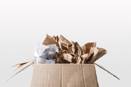 close up view of cardboard box with papers inside isolated on whiteの写真素材