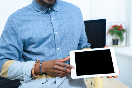 African american man showing digital tablet screenの写真素材