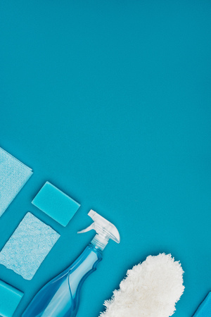 top view of washing sponges and spray bottle isolated on blueの写真素材