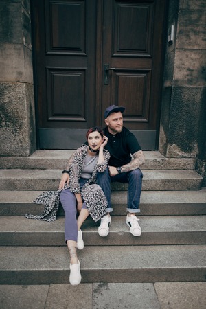 beautiful young couple sitting together on stairs in Dresden, Germanyの写真素材