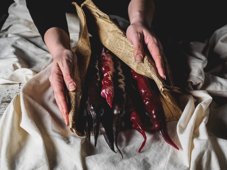 cropped shot of woman holding traditional geoogian desserts churchchelの写真素材