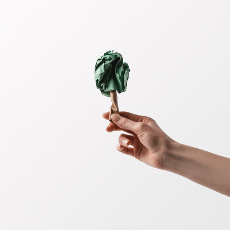 cropped shot of woman holding handmade tree in hand, recycle conceptの写真素材