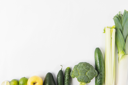 Composition of green vegetables in a row isolated on white backgroundの写真素材
