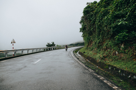 HAI VAN PASS, VIETNAM - 03 JANUARY, 2018: back view of people riding motorbike on mountain road in Hai Van Pass, Vietnamのeditorial素材