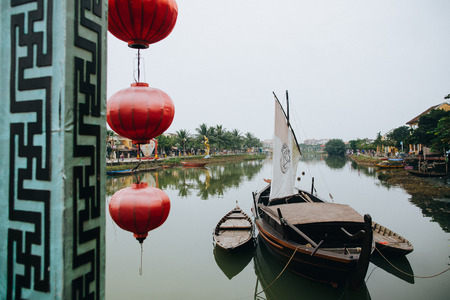 HOI AN, VIETNAM - 03 JANUARY, 2018: red oriental lanterns and wooden boats in Hoi An, Vietnamのeditorial素材