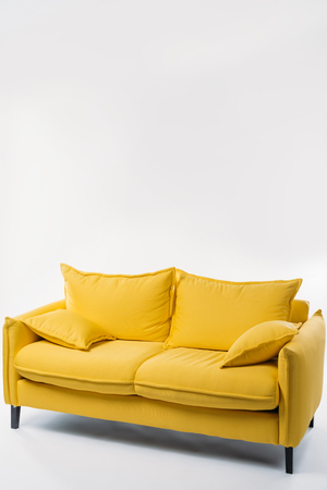 studio shot of trendy yellow sofa, on whiteの写真素材