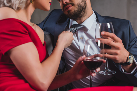 cropped shot of sexy stylish couple drinking wine togetherの写真素材