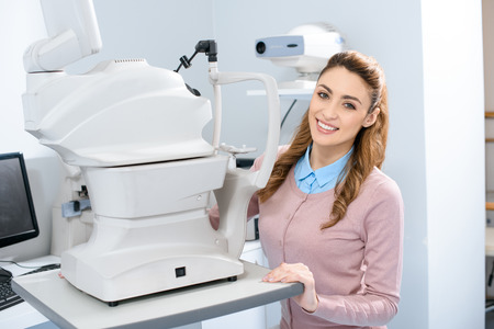 happy young woman looking at camera in oculist consulting room