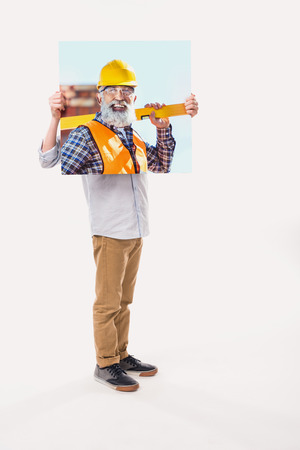 little boy pretending to be professional builder, isolated on whiteの写真素材