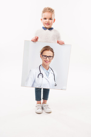 adorable child pretending to be a doctor, isolated on whiteの写真素材