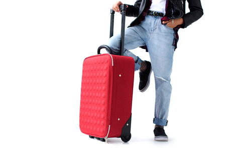 Cropped shot of little child in stylish clothing with suitcase isolated on whiteの写真素材