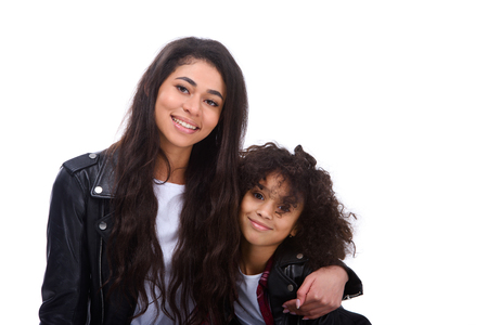 Mother and daughter in leather jackets isolated on whiteの写真素材