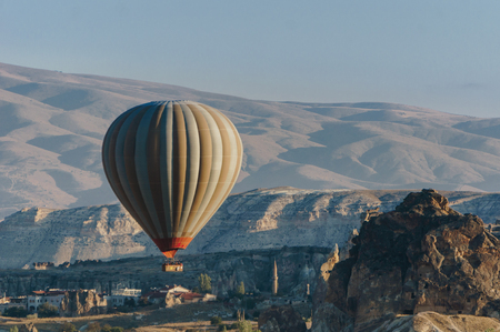 Hot air balloon flying in Goreme national park, fairy chimneys, Cappadocia, Turkeyの写真素材