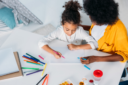 high angle view of african american mother drawing with daughterの写真素材