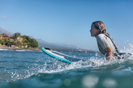 Surf woman surfing the wave in ocean