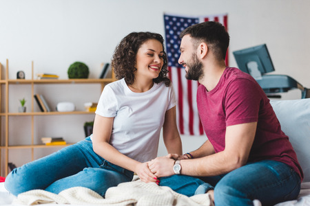 Smiling young couple holding hand of each otherの写真素材
