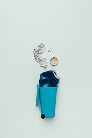 Top view of trash bin with assorted garbage isolated on grey, recycling conceptの写真素材