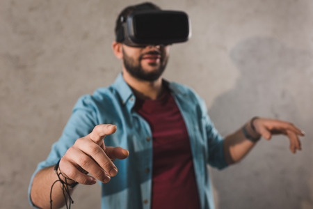 Smiling man using virtual reality headset