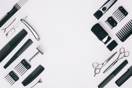 top view of arrangement of various barber tools isolated on grey