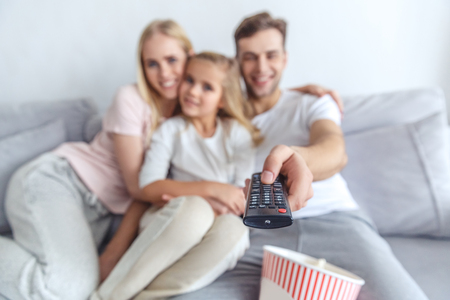 close-up shot of happy family using tv remoteの写真素材