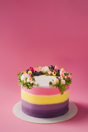 close up view of decorated cake isolated on pinkの写真素材