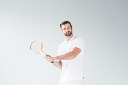 handsome tennis player with tennis racket isolated on whiteの写真素材
