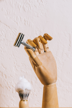 close up view of brush with shaving foam and blade in wooden handの写真素材