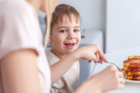 cropepd shot of mother feeding her sonの写真素材