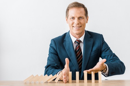 smiling businessman with blocks wood game in office, insurance conceptの写真素材
