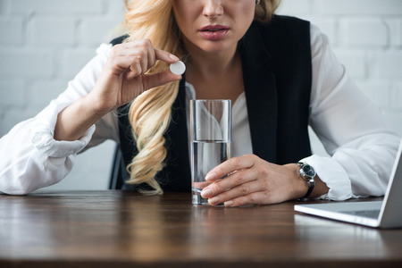 cropped image of businesswoman holding pillの写真素材