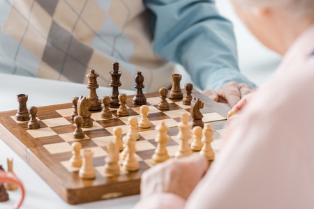 close up of senior couple playing chess togetherの写真素材