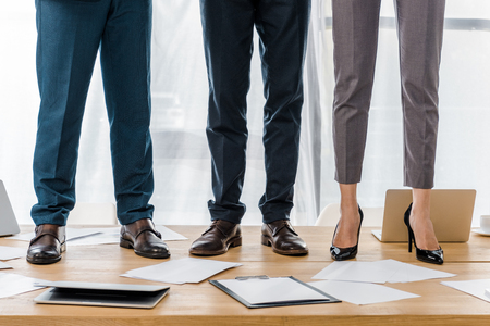 business people standing at wooden table in officeの写真素材