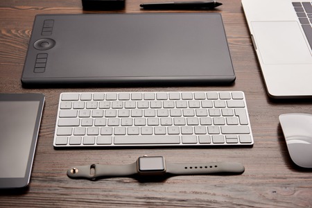 Close-up shot of different devices on graphics designer workplace