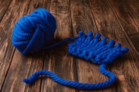 close up view of blue yarn for knitting on wooden surfaceの写真素材