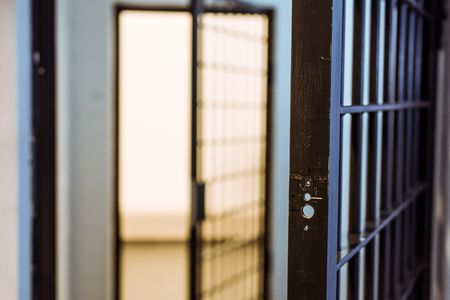 Prison bars and empty prison cellの写真素材