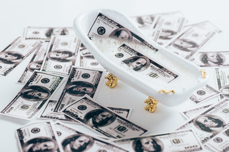 Close-up view of dollar banknotes and small bathtub, money laundering conceptの写真素材