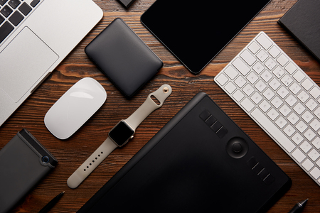 flat lay with different devices on wooden workplace