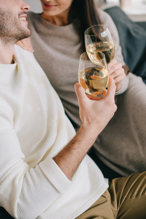 cropped shot of young couple drinking wine at homeの写真素材