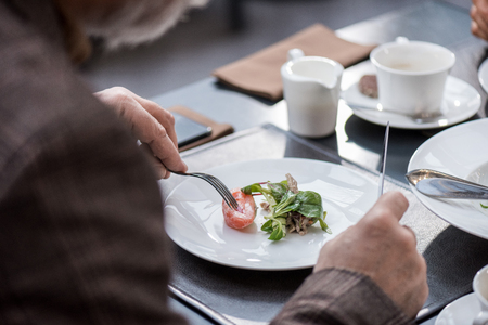 cropped shot of man having dinner in restaurantの写真素材