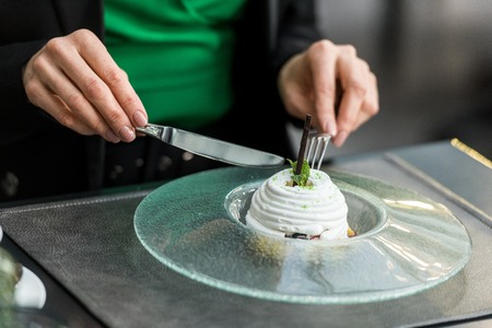 partial view of woman eating dessert in restaurantの写真素材