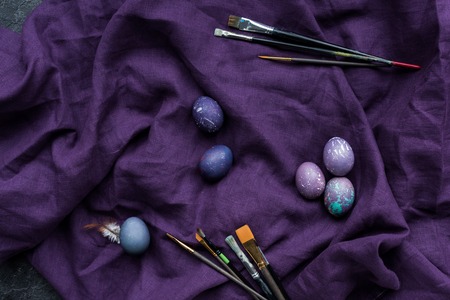 Easter eggs and brushes on textile backgroundの写真素材