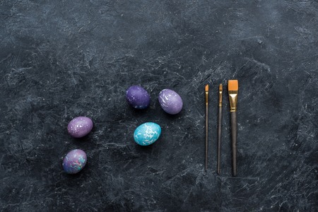 Easter eggs and brushes on dark backgroundの写真素材