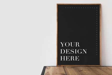 big blackboard with text your design here on wooden table on whiteの写真素材