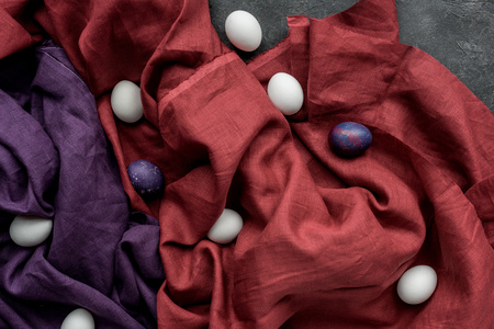 White and colored chicken eggs on textile backgroundの写真素材