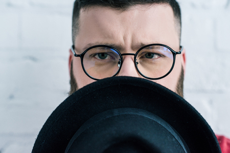 obscured view of stylish man in eyeglasses with hatの写真素材