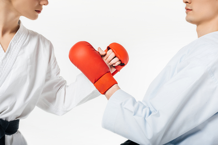 cropped image of karate fighters touching with gloves isolated on whiteの写真素材