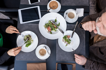 overhead view of man and woman having dinner together in restaurantの写真素材