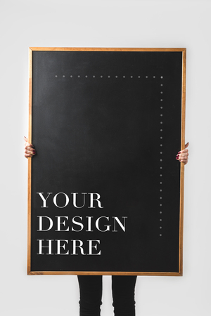 woman holding big black board with text your design here isolated on whiteの写真素材