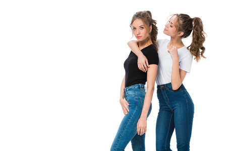 attractive young twins hugging isolated on whiteの写真素材